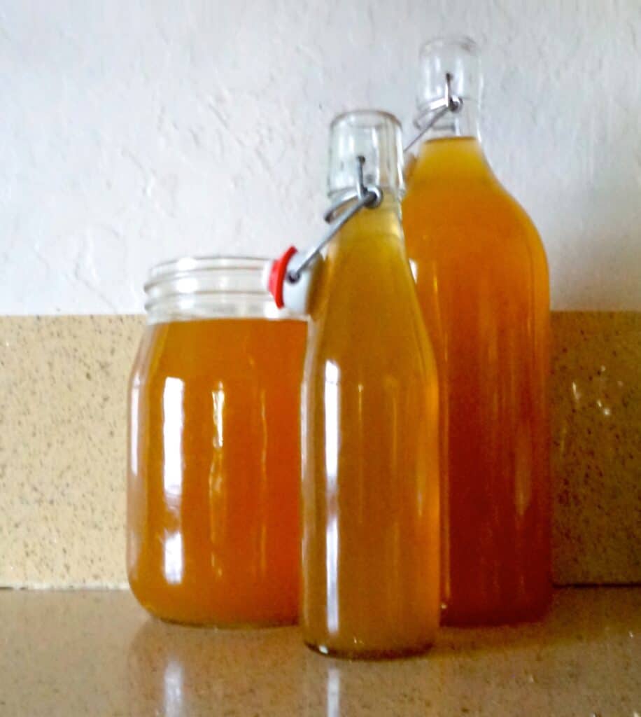 image of three glass containers filled with vegetable stock