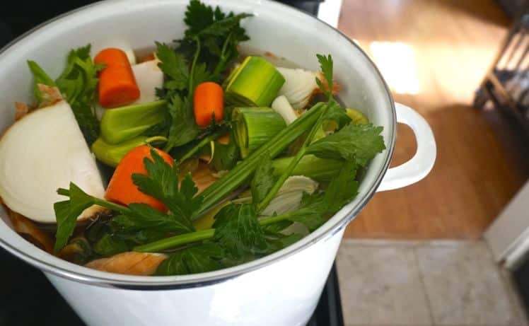 overhead image of a full pot of uncooked vegetable scraps