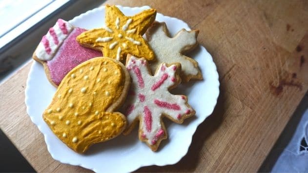 plate filled with vegan christmas cookies with vegan food coloring icing