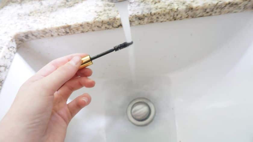 rinsing mascara brush under water