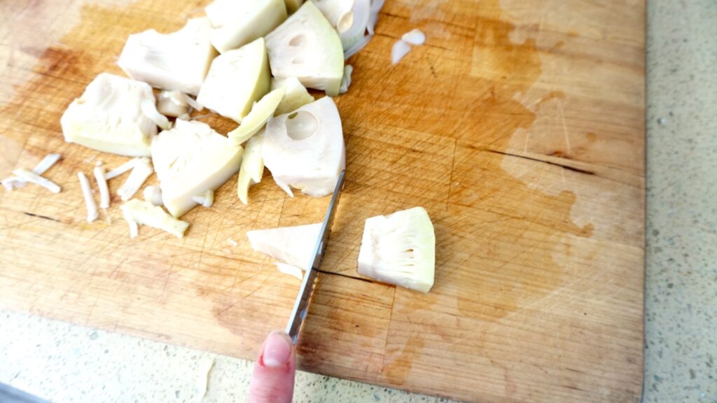 cutting jackfruit on a cutting board