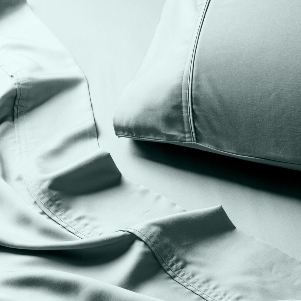 Things to buy organic - a close up of a green pillowcase with matching sheets