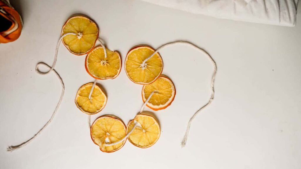 Dried oranges on a twine string to illustrate eco friendly gift wrapping ideas.