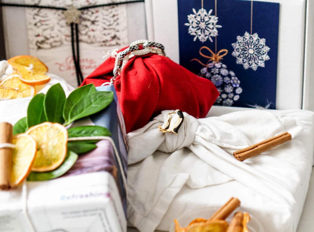 Photos wrapped in cloth napkins and secured with broaches or jewelry to how to wrap a gift without tape.