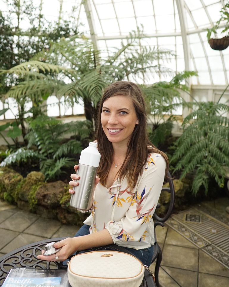 woman drinking out of water bottle