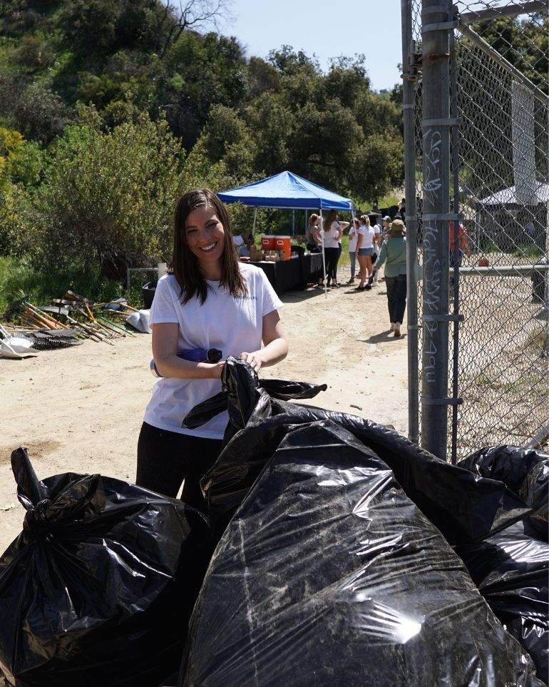 woman with giant bags of waste