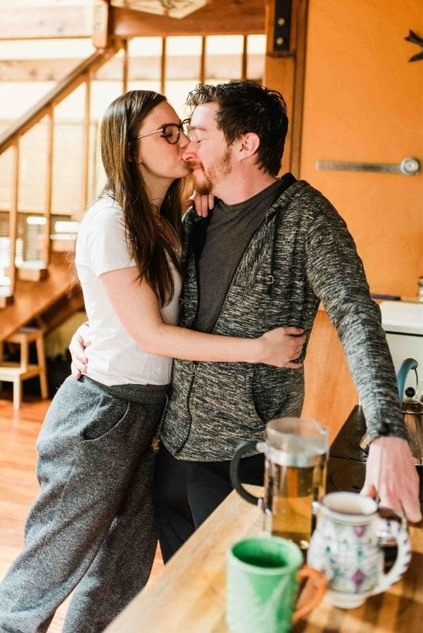 people hugging with a cup of tea