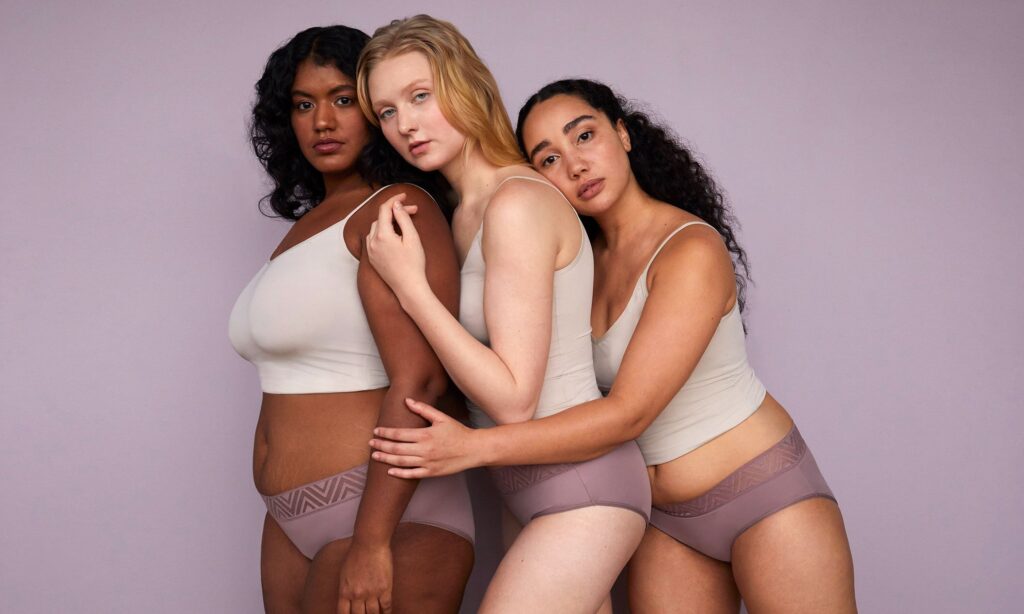 three women wearing thinx panties