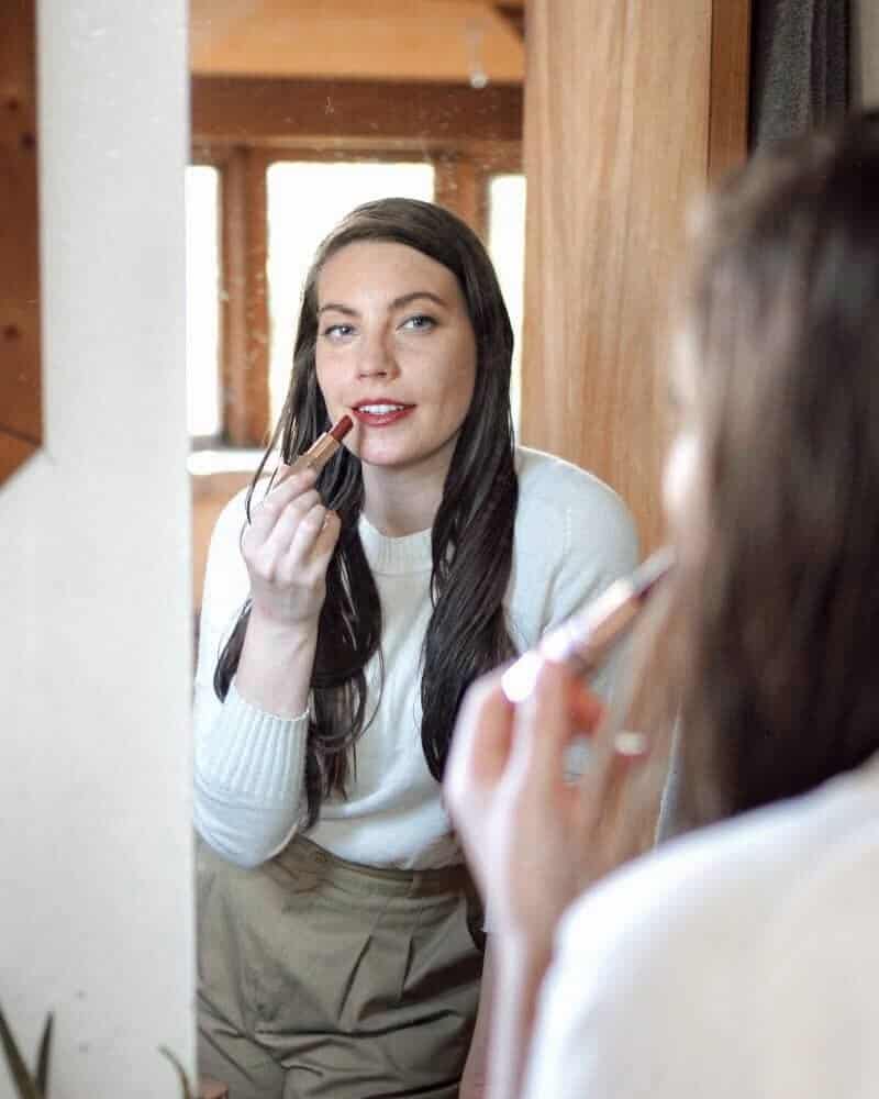 putting on lipstick