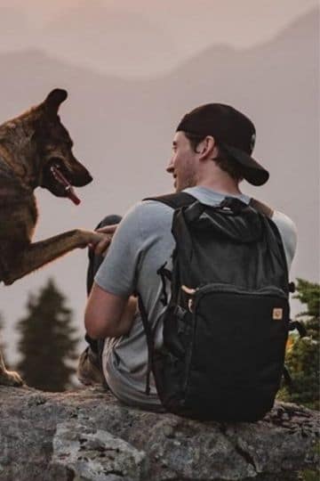 person with eco backpack and dog