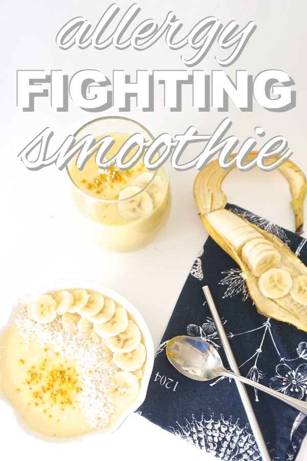 top view of a pineapple and mango smoothie served in a bowl with a spoon, straw, and sliced banana