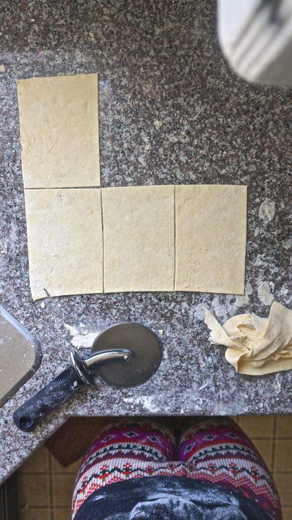 raw toaster strudel dough being cut into rectangles