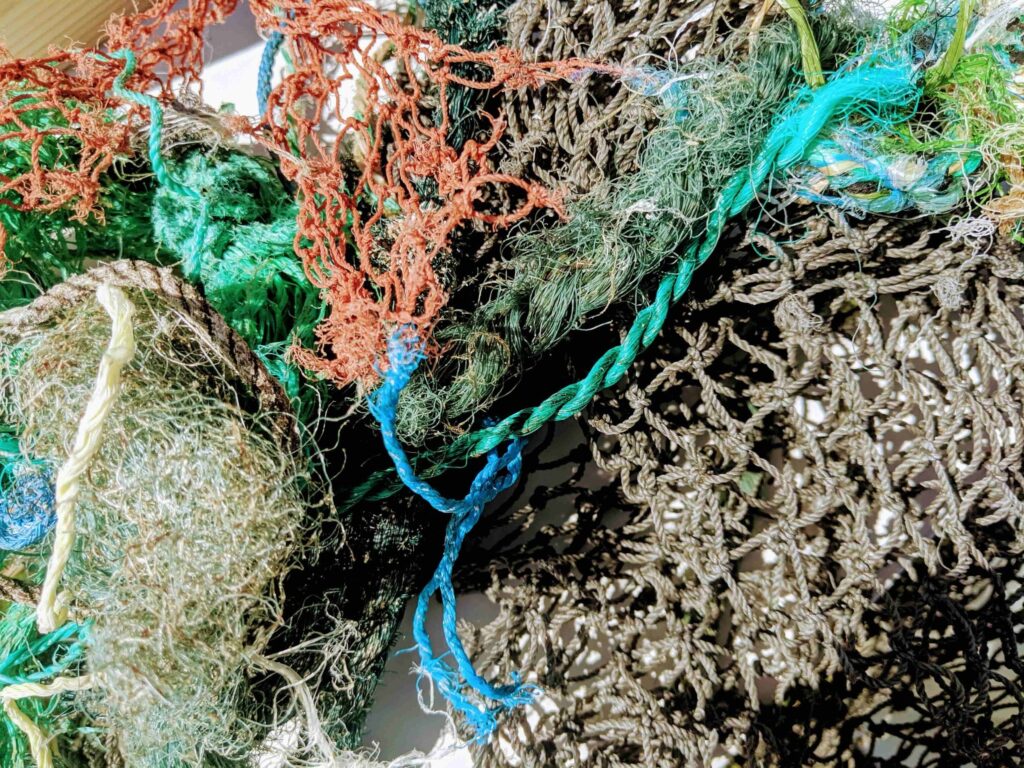 pile of fishing nets found in the ocean - we can save the ocean by picking up after ourselves