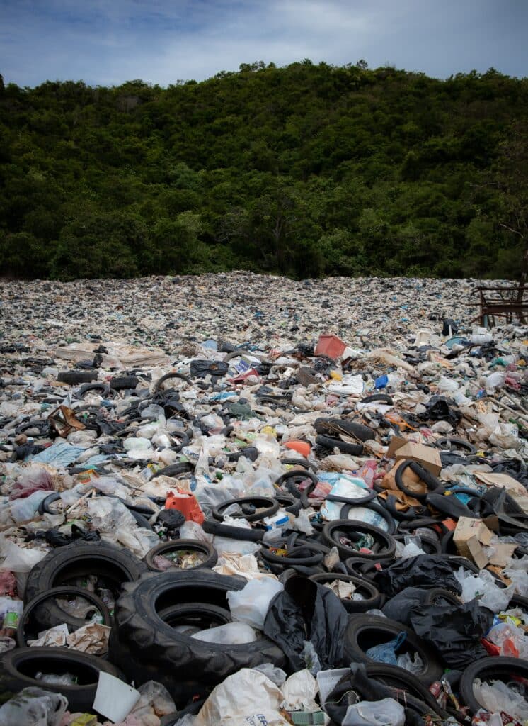 landfill full of tires and plastic waste depicts why sustainability practices are so necessary