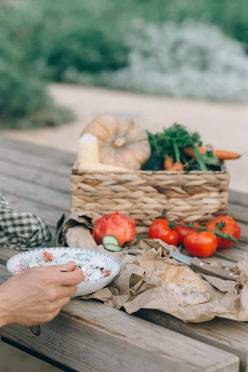 a plate of food and basket of produce served at a farm to table restaurant