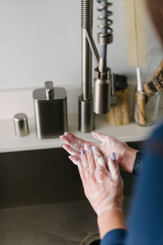 A woman washing her hands with DIY liquid hand soap