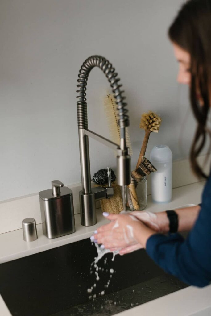 woman washing her hands after making this liquid soap recipe