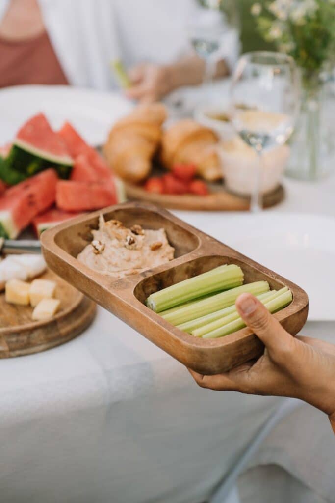 Celery and hummus in a serving tray