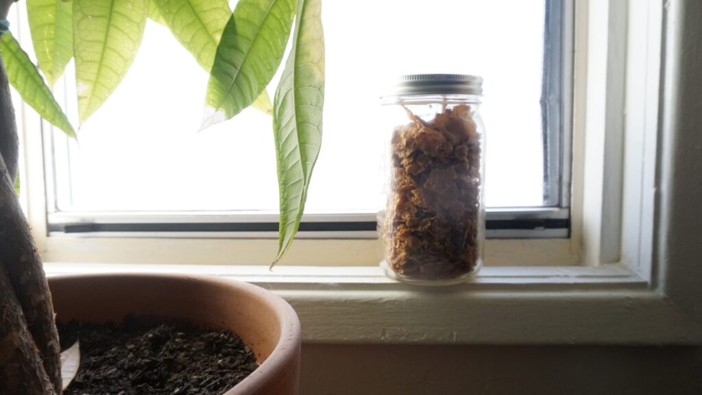 Jar full of bulk ingredients. Sustainable grocery shopping involves taking your own containers.