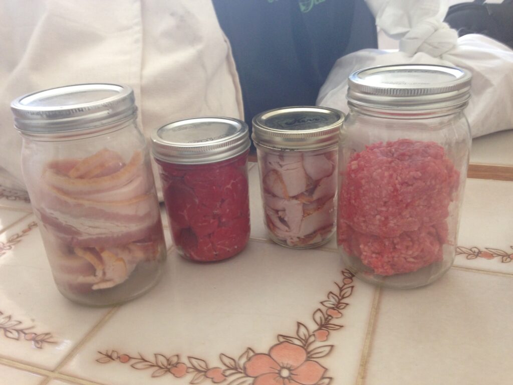 Mason jars filled with meat from the butcher - sustainable grocery shopping