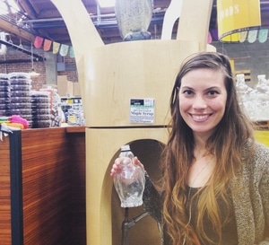 Woman at a bulk grocery store, zero waste grocery shopping