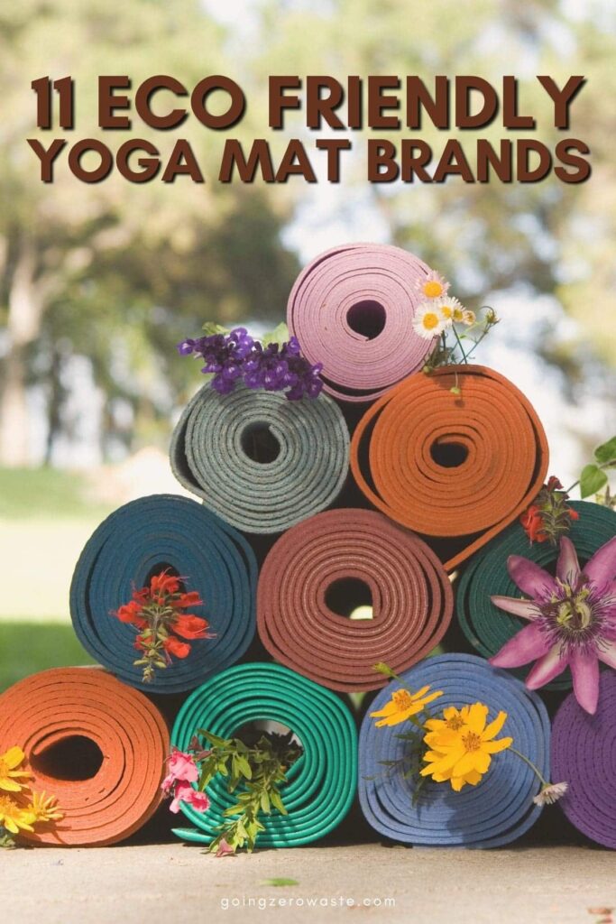 Photo of rolled and stacked yoga mats with flowers displayed across them and overlay text reading "11 eco friendly yoga mat brands"