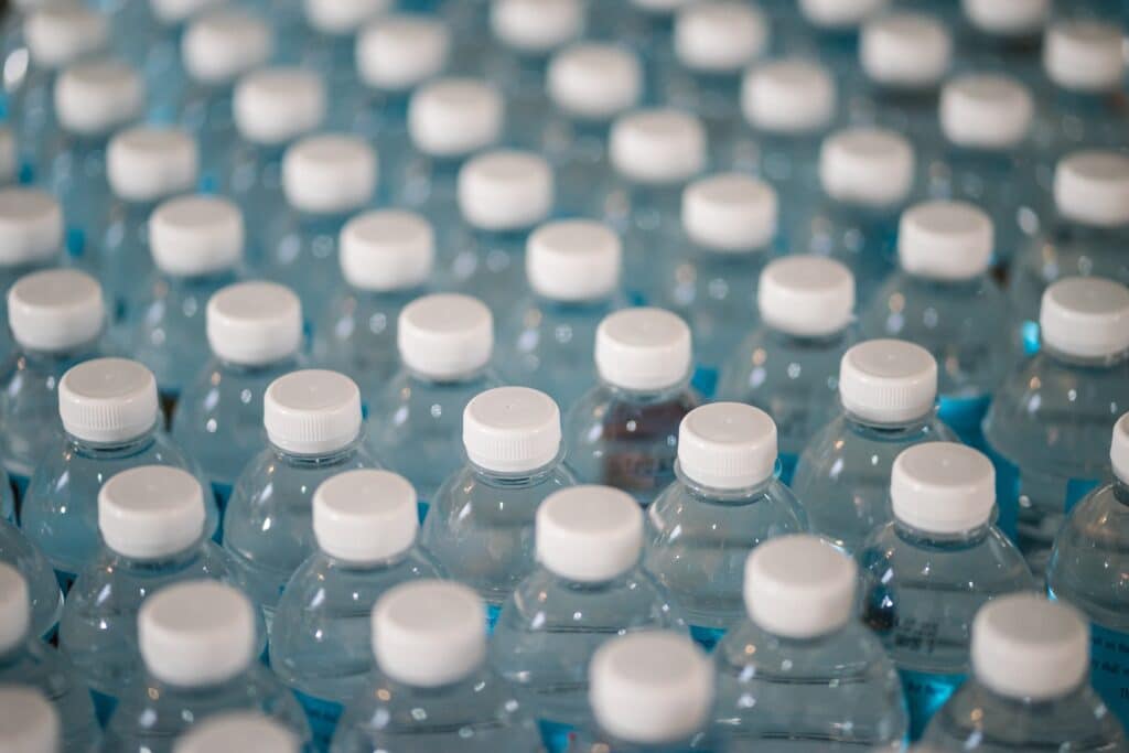 a production line of plastic water bottles in a post about the best non plastic water bottle. 