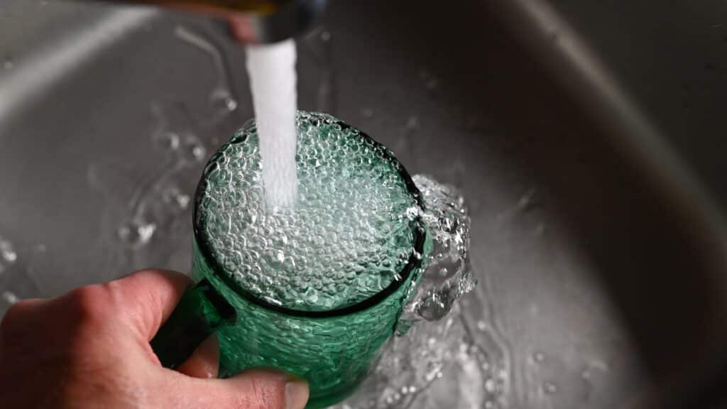 tap water filling a non plastic water bottle.