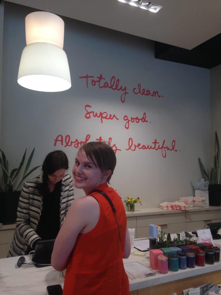 Woman at the counter of Credo, a sustainable beauty store, as part of this list of unique bachelorette party ideas. 
