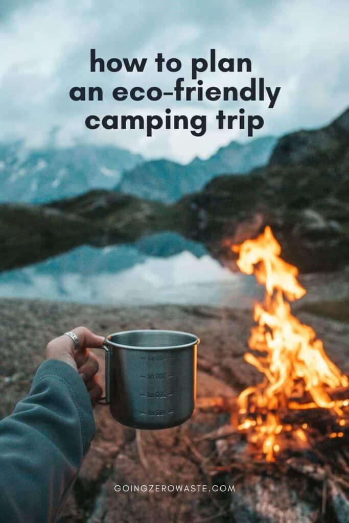 A woman's hand holding a camp mug in front of a fire in the mountains with overlay text reading "how to plan an eco friendly camping trip."