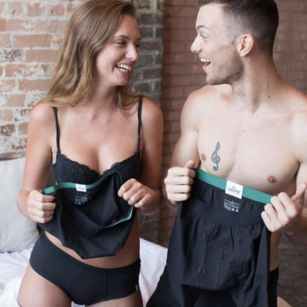 a man and woman each holding a pair of his + hers undies for a sustainable Valentine's Day