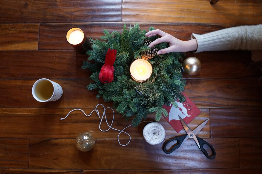 A photo of a table top wreathe being made for sustainable Christmas decorations.