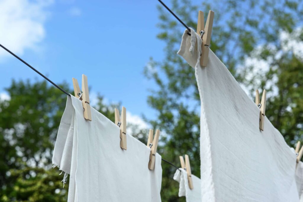 Linens clipped to a laundry wire to illustrate a post about non toxic laundry detergent. 