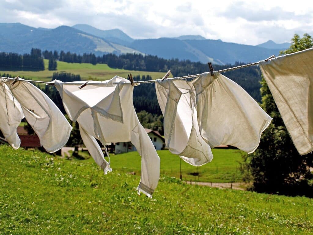 Is fabric softener bad? Clothes drying on a clothes line to illustrate an educational post about the dangers of this popular product. 