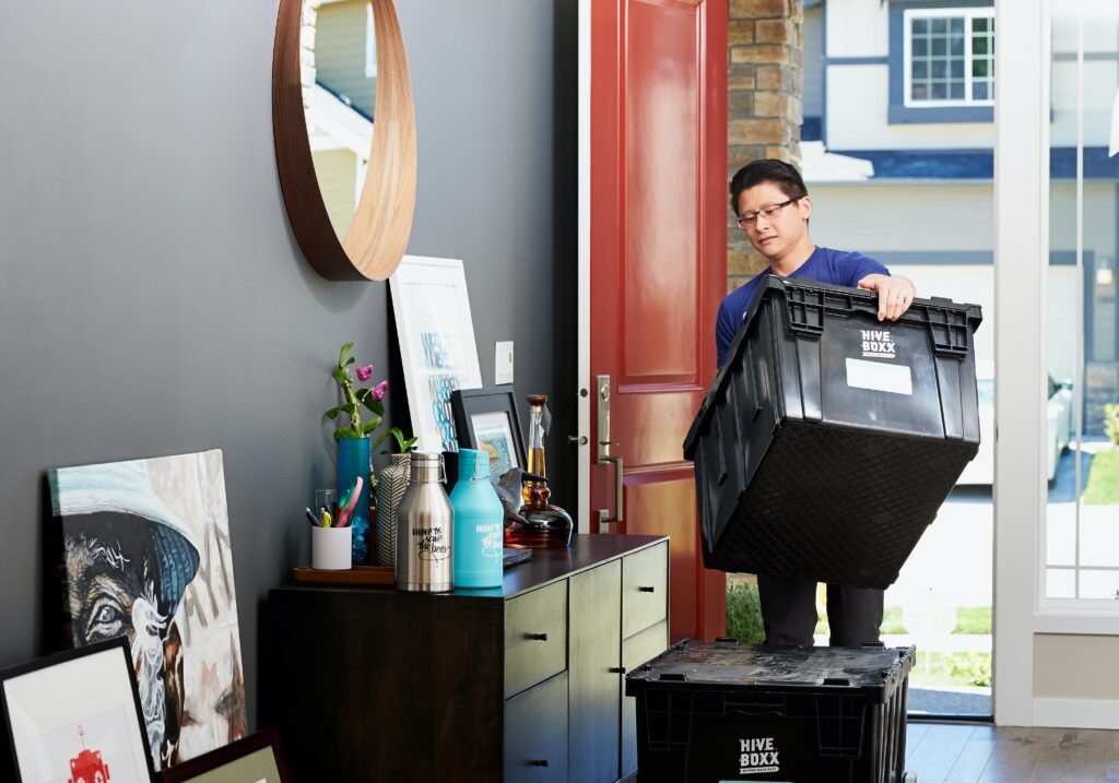 Hive Box rental for moving - a man carrying a reusable tote for moving