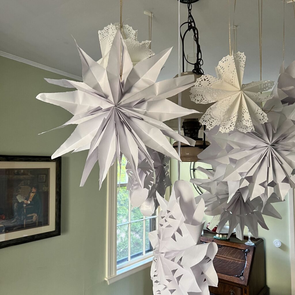 image of paper snowflakes hanging in room