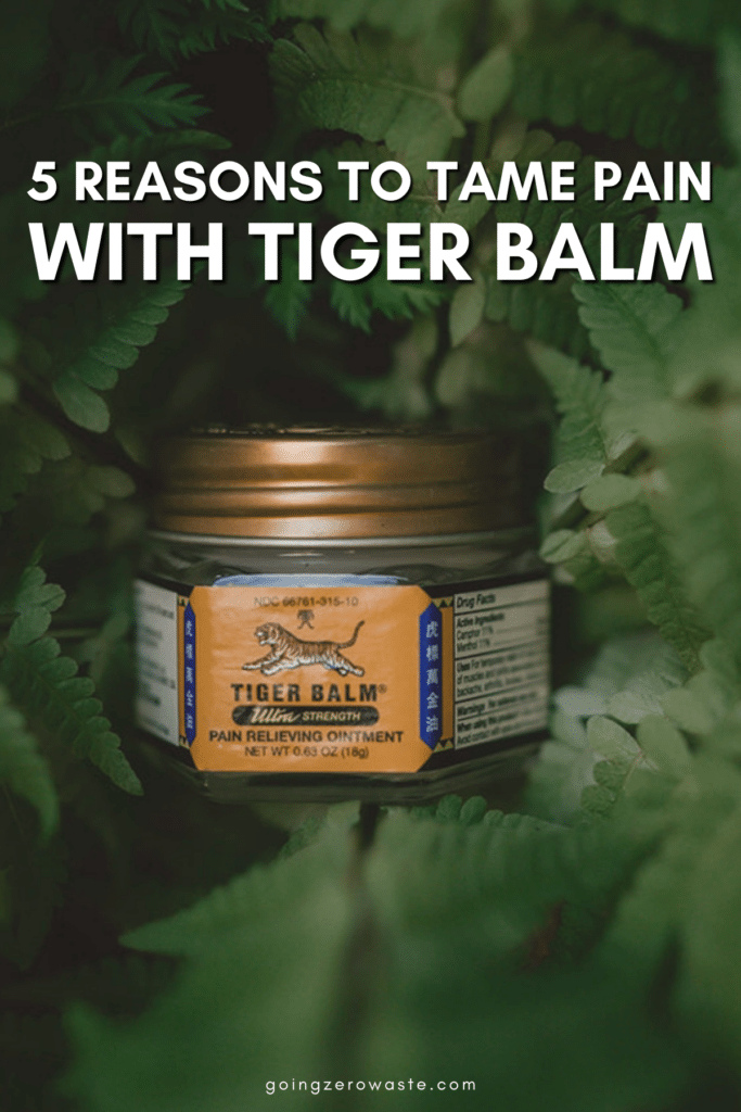 Jar of Tiger Balm nestled in fern leaves with overlay text reading "5 Reasons to Tame Pain with Tiger Balm"