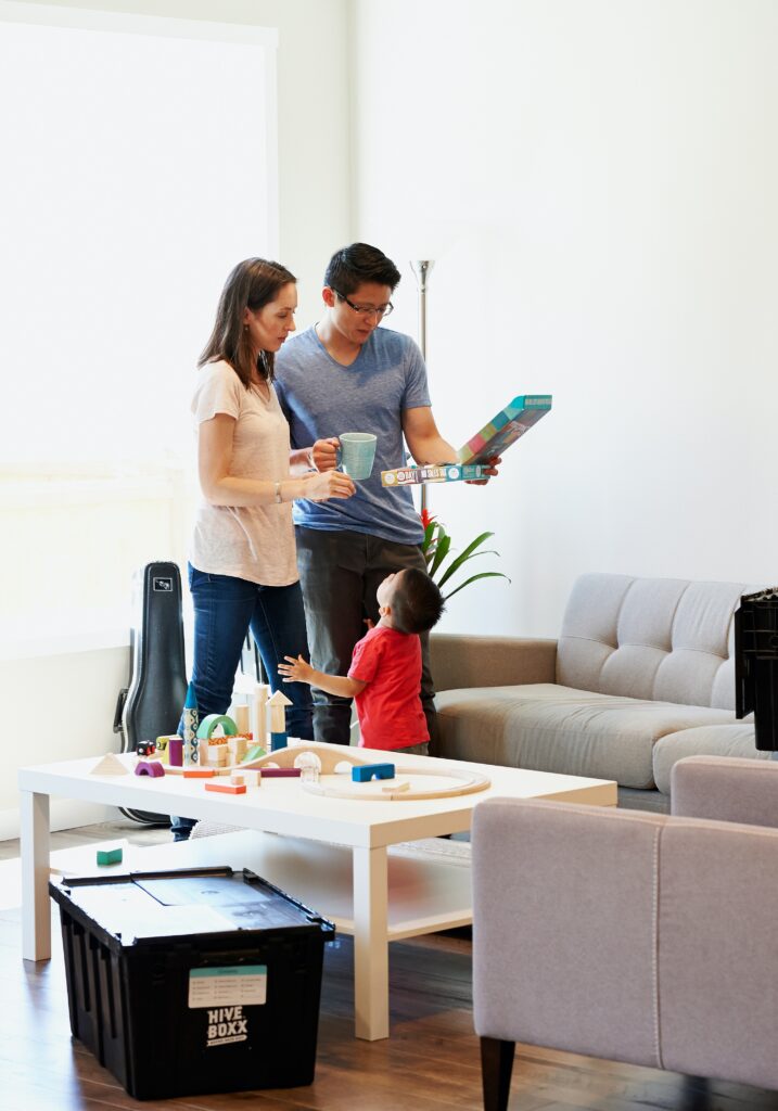 A family standing in their living room packing Hive Boxes 