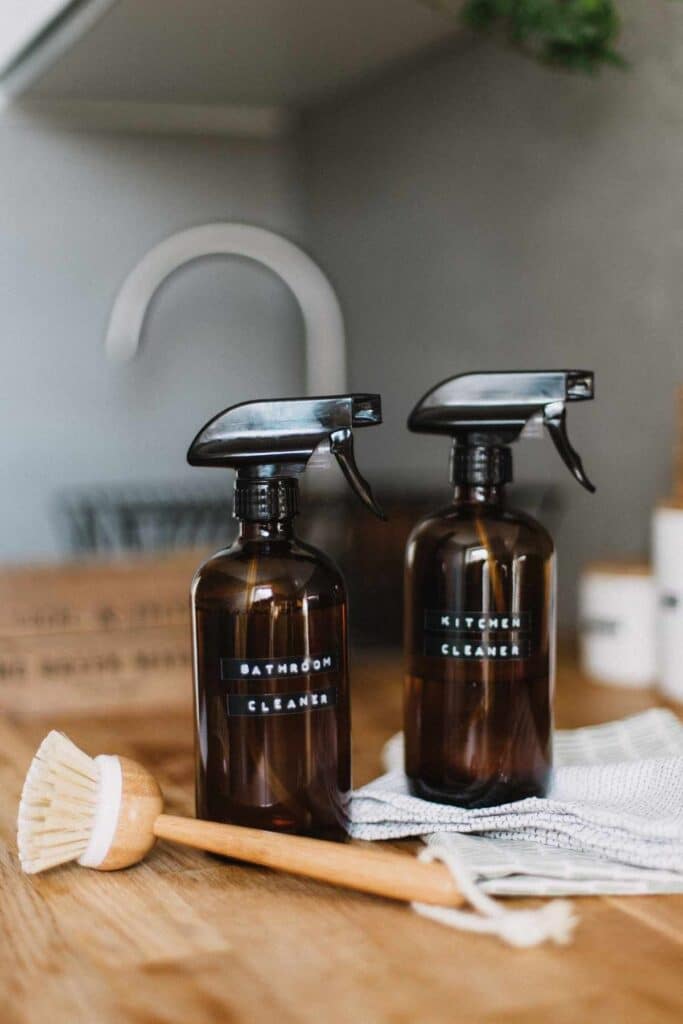 2 brown spray bottles filled with bathroom cleaner and kitchen cleaner to illustrate alternatives to Amazon for cleaning supplies