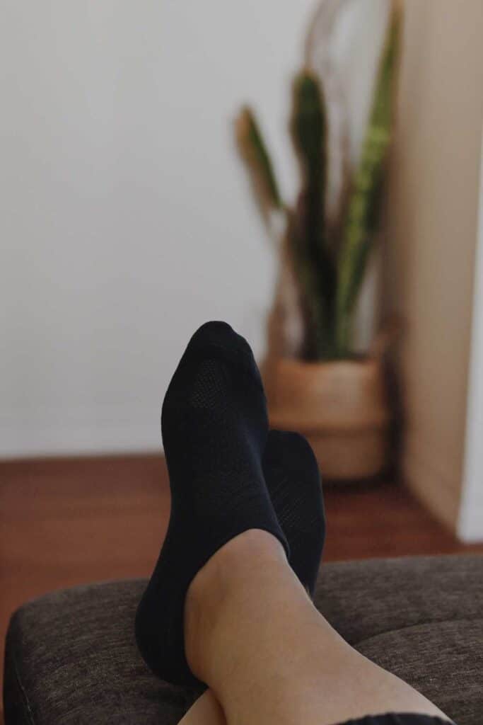 Legs wearing black socks to illustrate Amazon alternatives for clothing basics