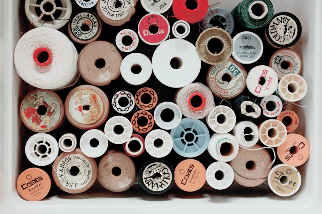 Top view of various spools of thread and string to illustrate a post about how to repair a number of household items. 