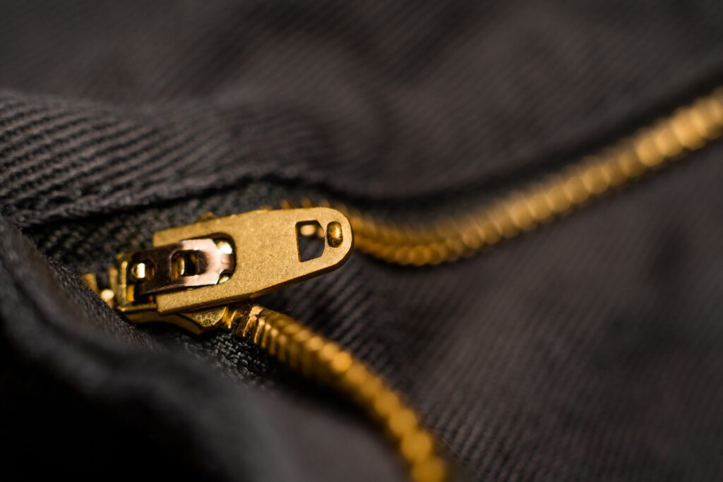 Photo of a gold zipper on black denim