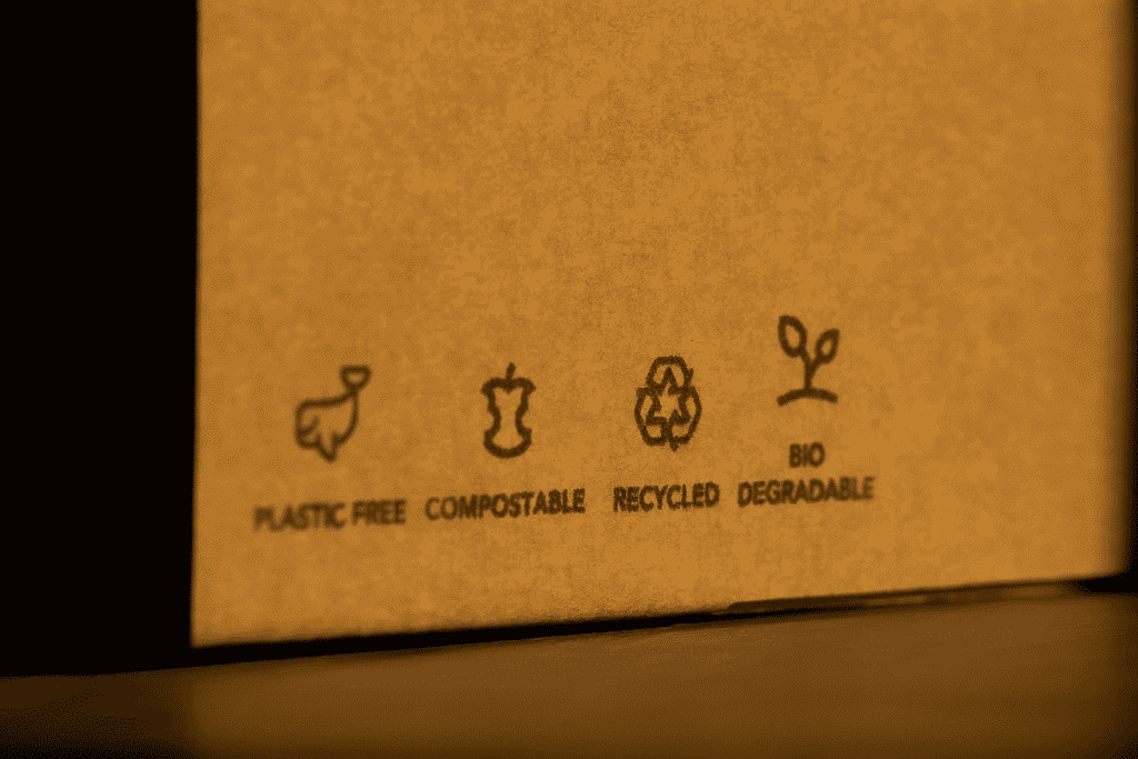 Is biodegradable the same as compostable? A cardboard box with iconography showing that it is plastic free, compostable, recycled, and biodegradable.