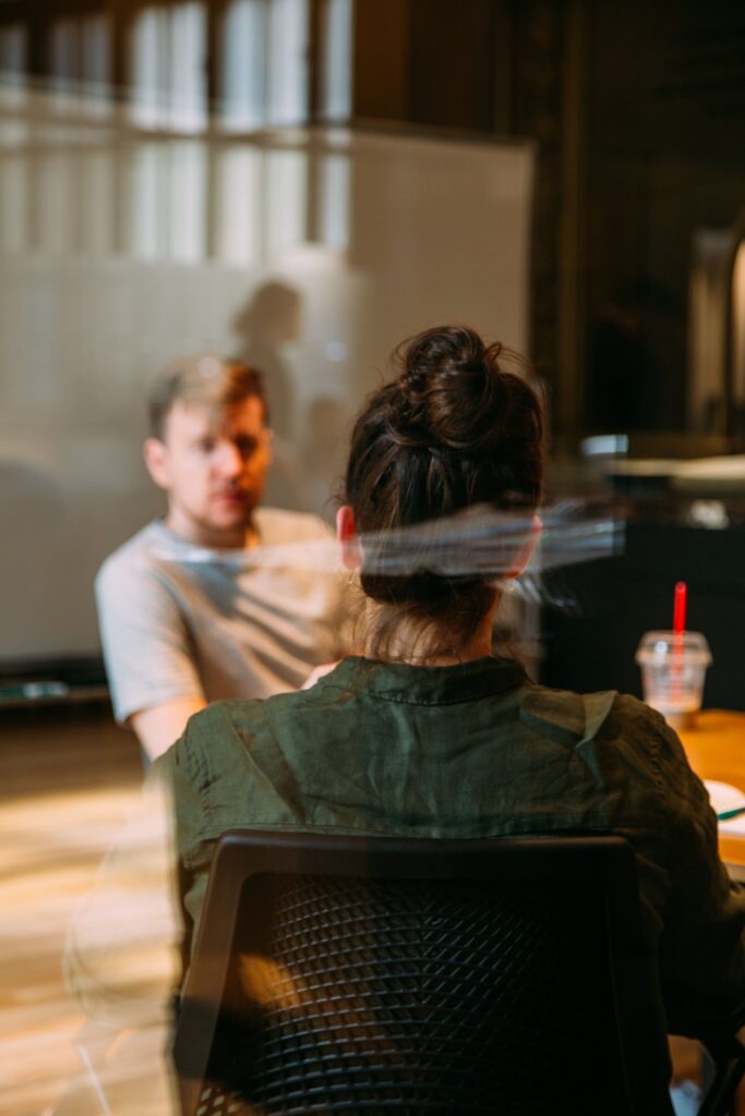 A green dream team meeting at a table to make their workplace more sustainable. 