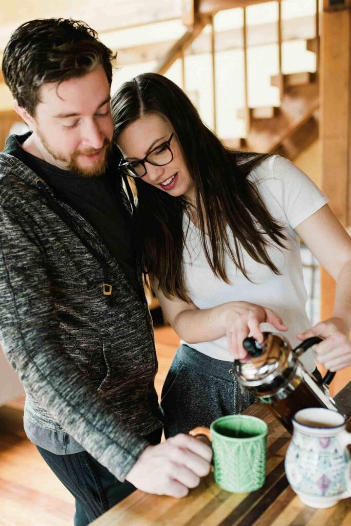 How to take care of yourself: a woman and her partner pouring herbal tea to unwind. 