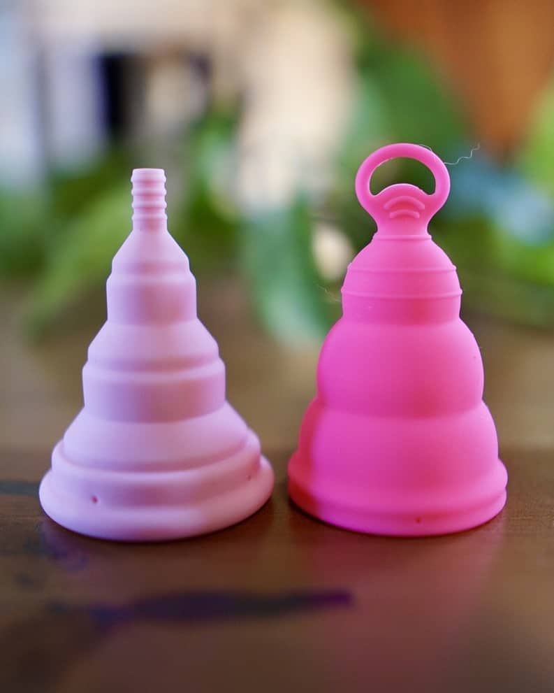 How to use period cup - two pink period cups lined up on a counter.