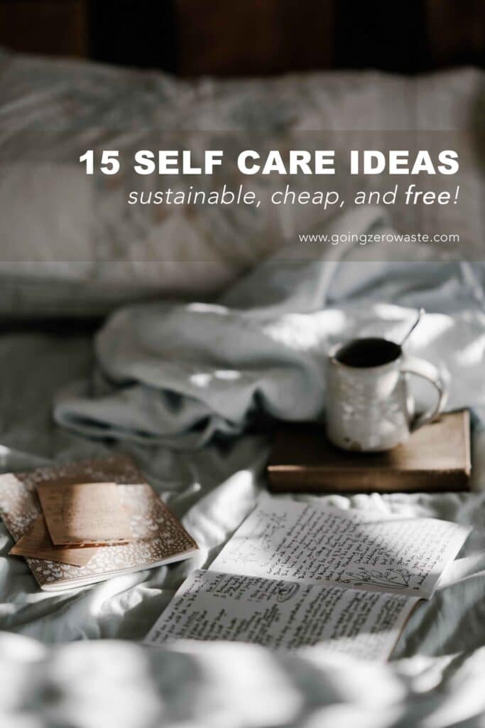 Stationary and a mug of tea laying on a bed with overlay text reading "15 self care ideas: sustainable, cheap, and free!"