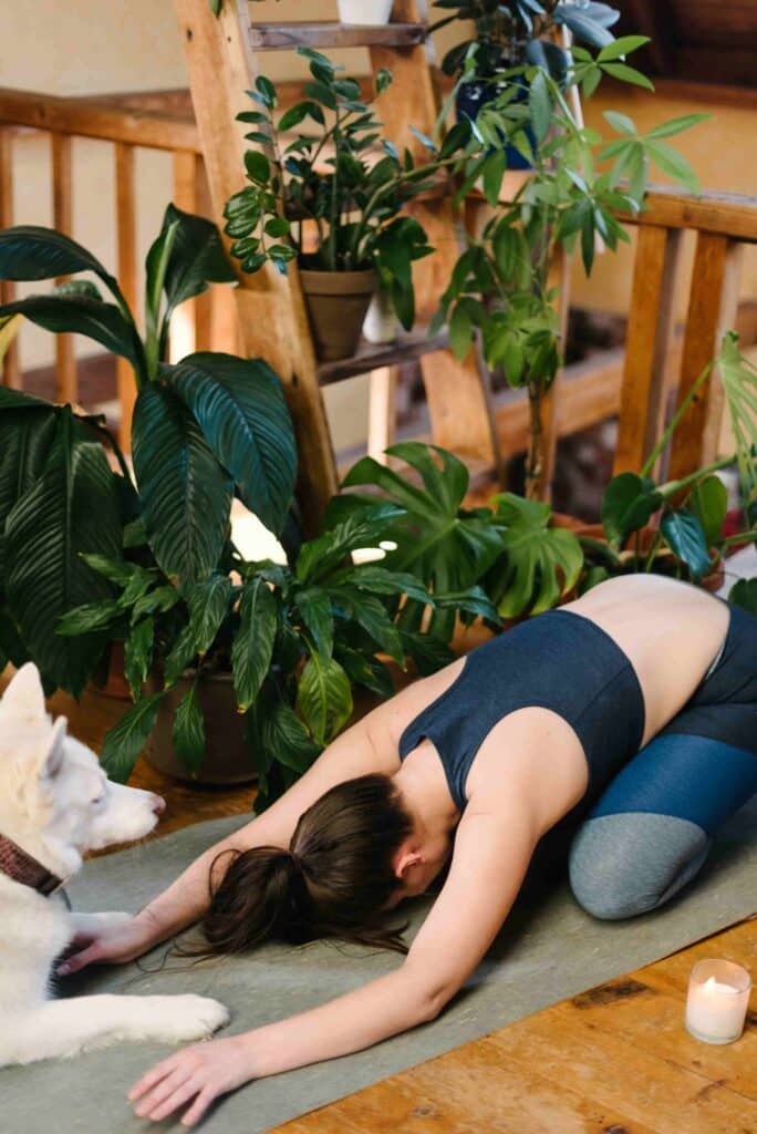 A woman stretching to demonstrate sustainable self care. 