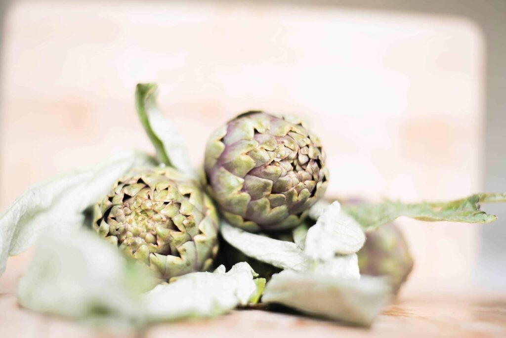 Close up shot of two artichokes to illustrate vegan recipes for two.