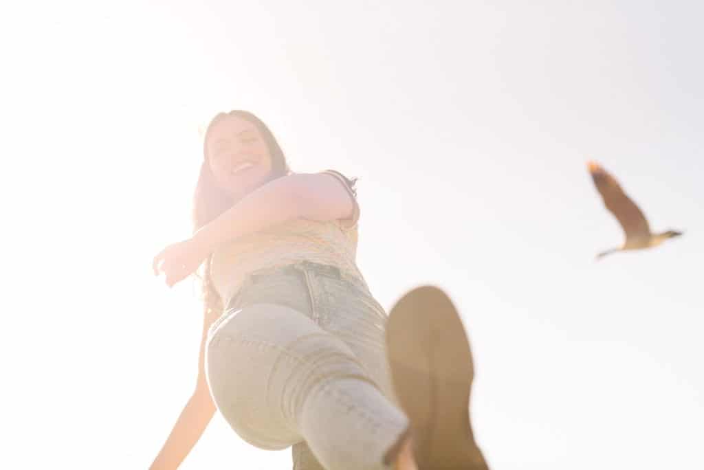 View from the bottom looking up of a woman stepping with a Wildling shoe